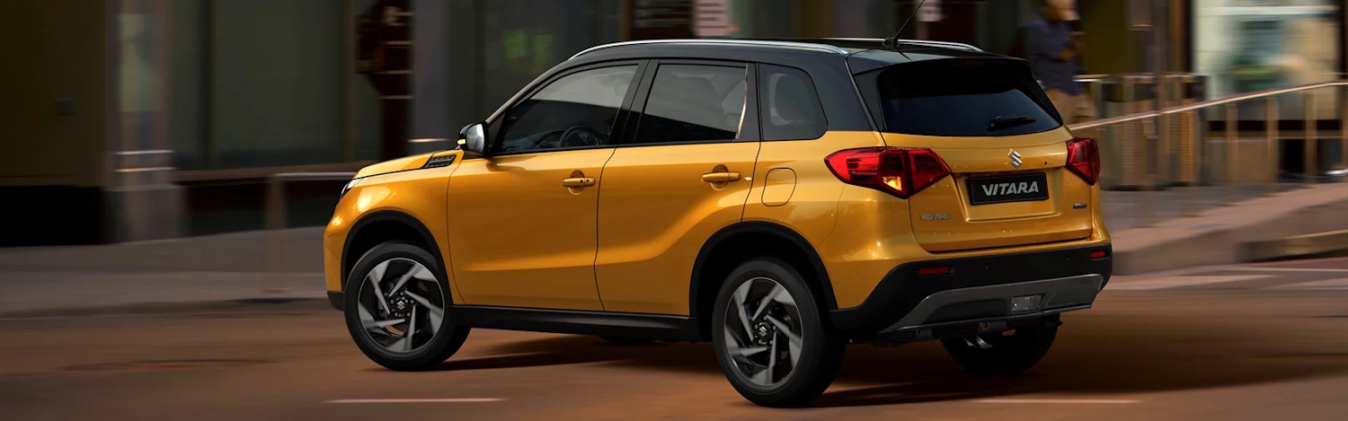 Side view of a yellow suzuki vitara