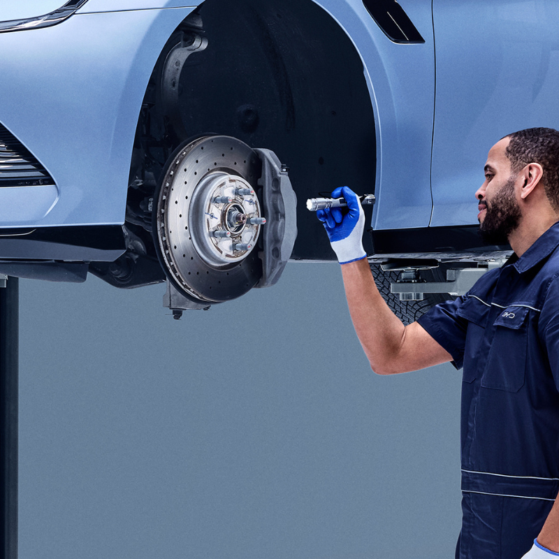 Mechanic Inspecting Brake Disc