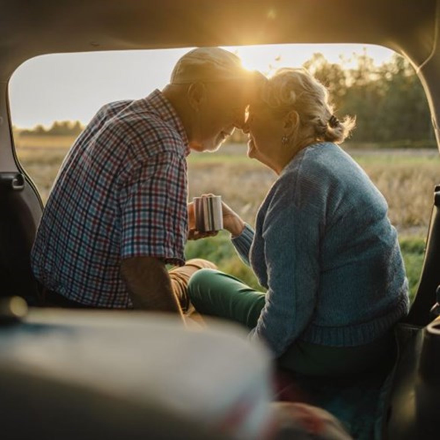 Old couple in the boot of their car