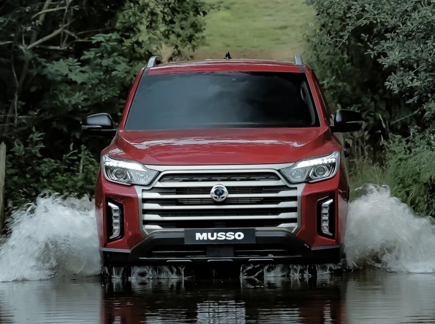 KGM Musso driving in shallow water