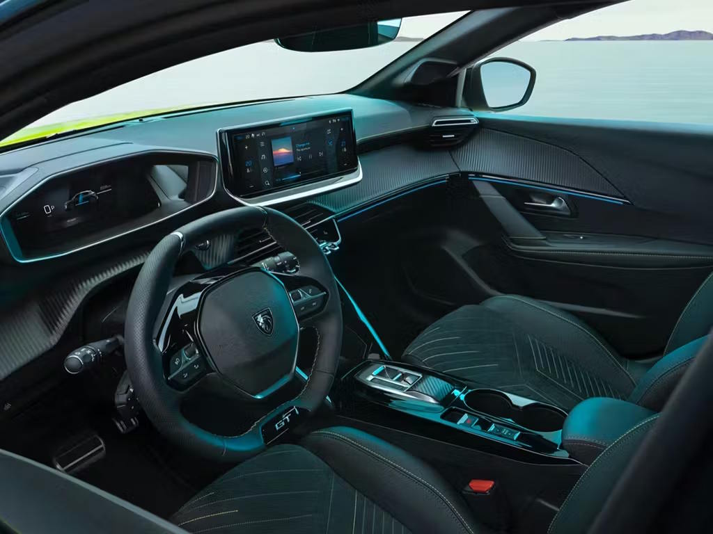 Modern Peugeot 208 cabin with compact steering wheel, digital dashboard and integrated infotainment touchscreen.