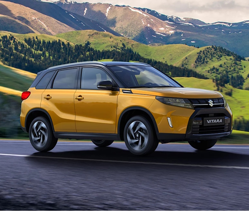 yellow Suzuki Vitara by the mountains