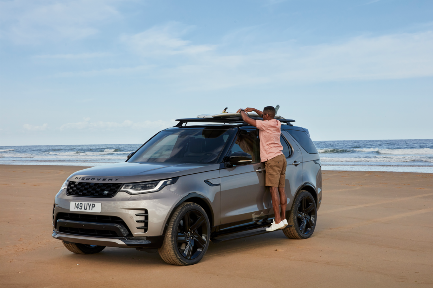 Land Rover Discovery parked on beach with roof rack fitted.