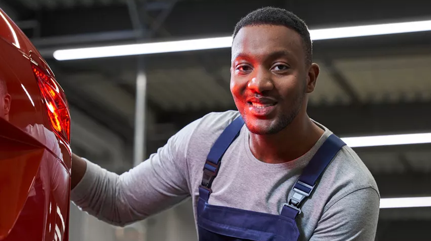 Volkswagen Mechanic Stood by Red VW
