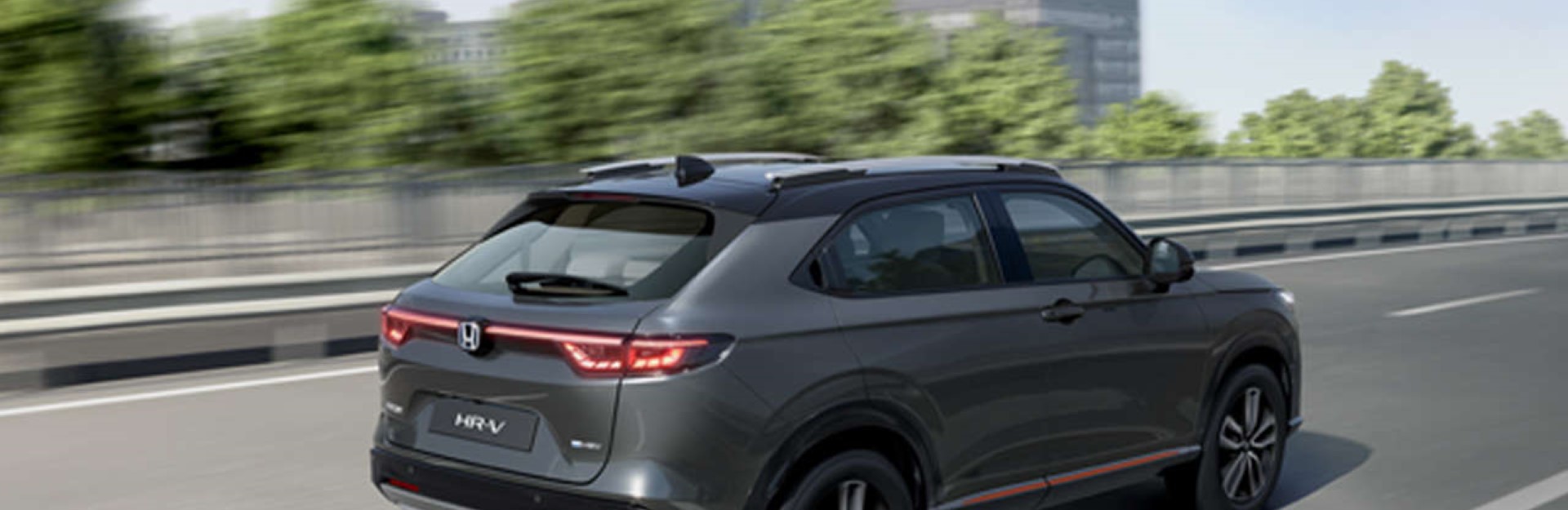 Grey Honda HR-V driving quickly on a city motorway.