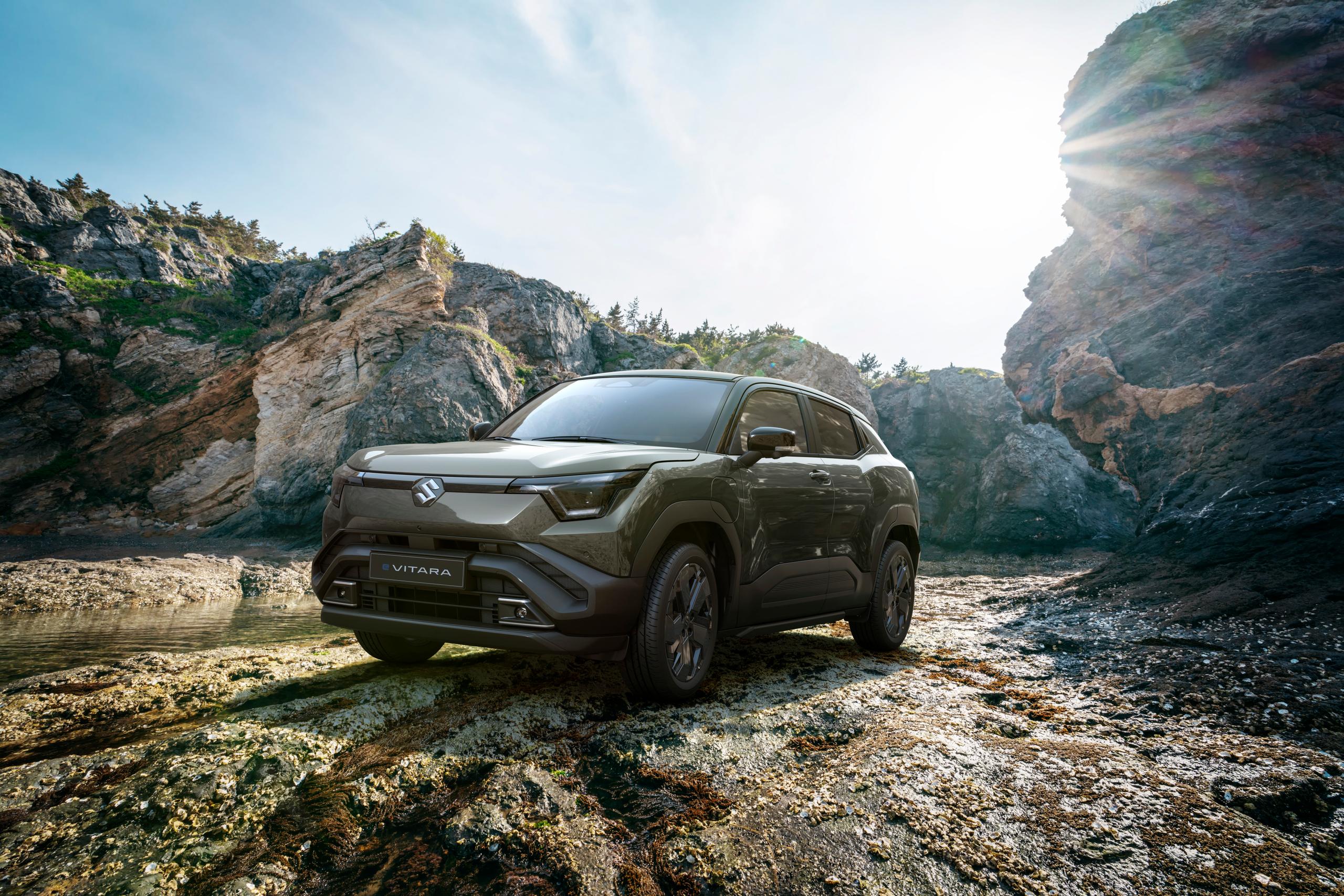 Suzuki e-vitara parked by the hills