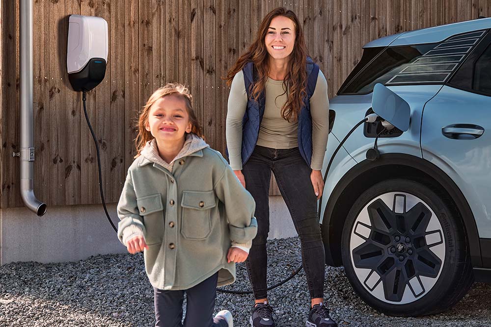 mother and child by a Ford charging