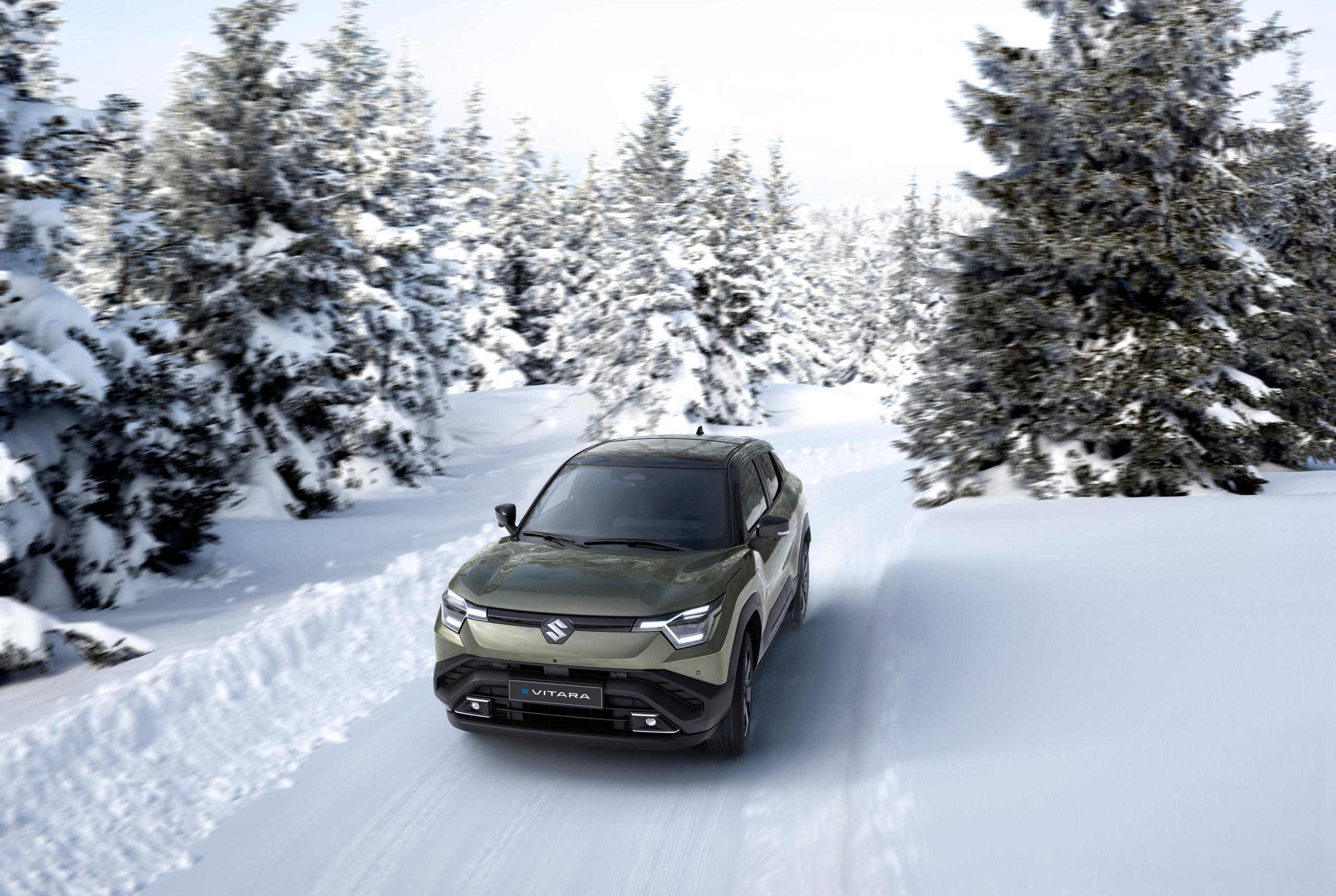 Suzuki e-vitara driving through a snow