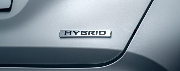 Close up of the word "HYBRID" on the rear of a car