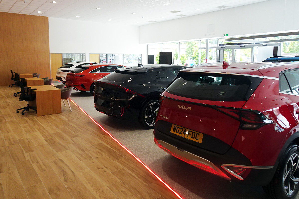 new kia cars lined up in a row 