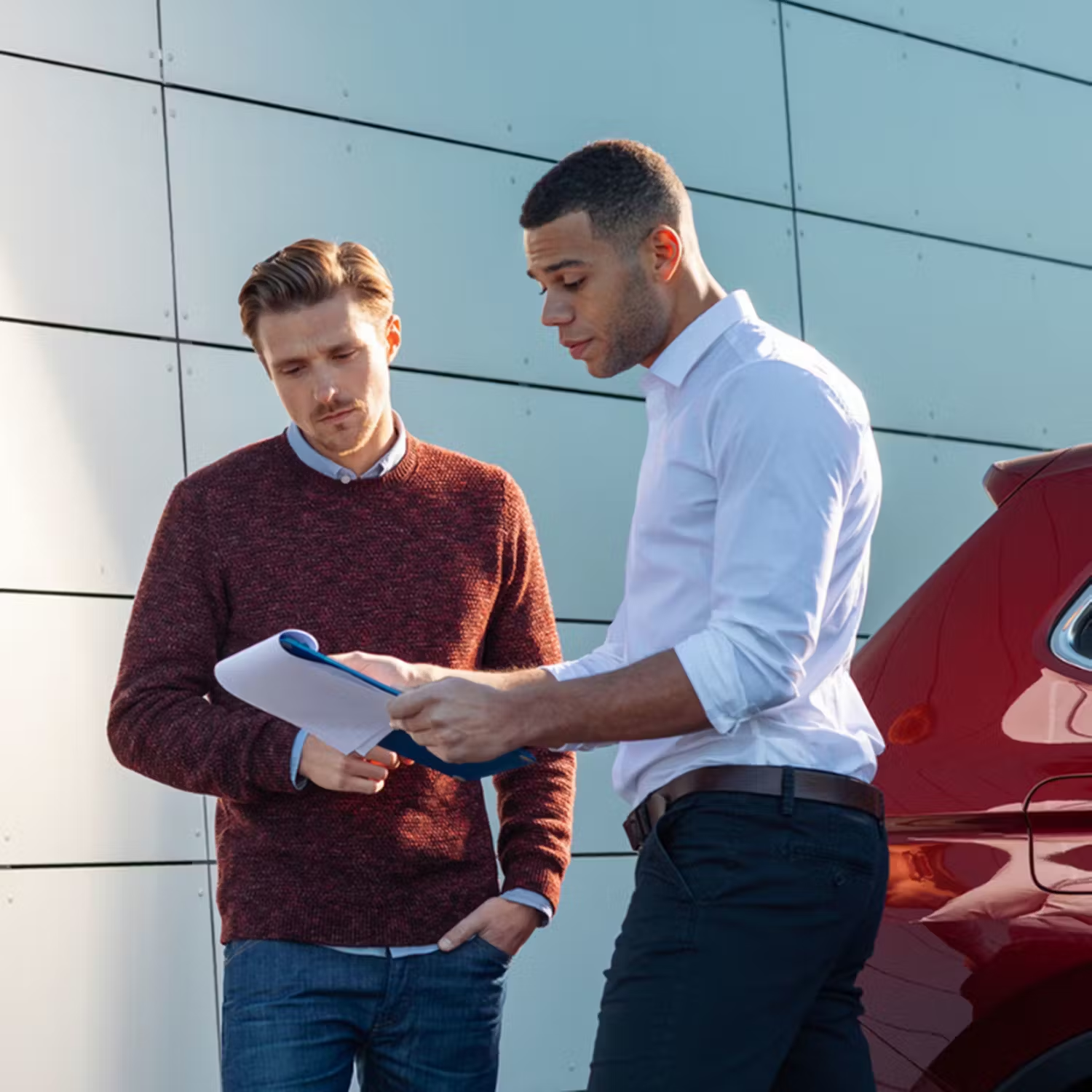 Salesman with customer looking at clipboard