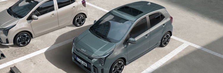 Two Kia Picanto cars parked side by side in a parking area.