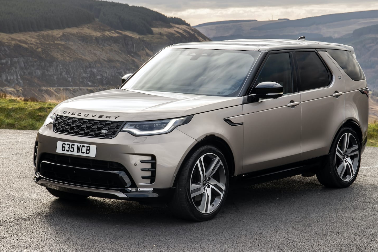 Land Rover Discovery parked on scenic countryside road.