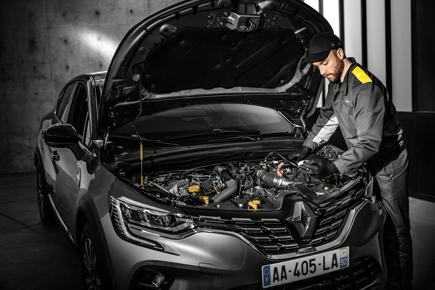 Renault Mechanic Inspecting Engine