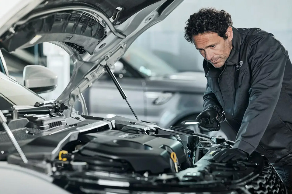 Land Rover Mechanic Inspecting Engine