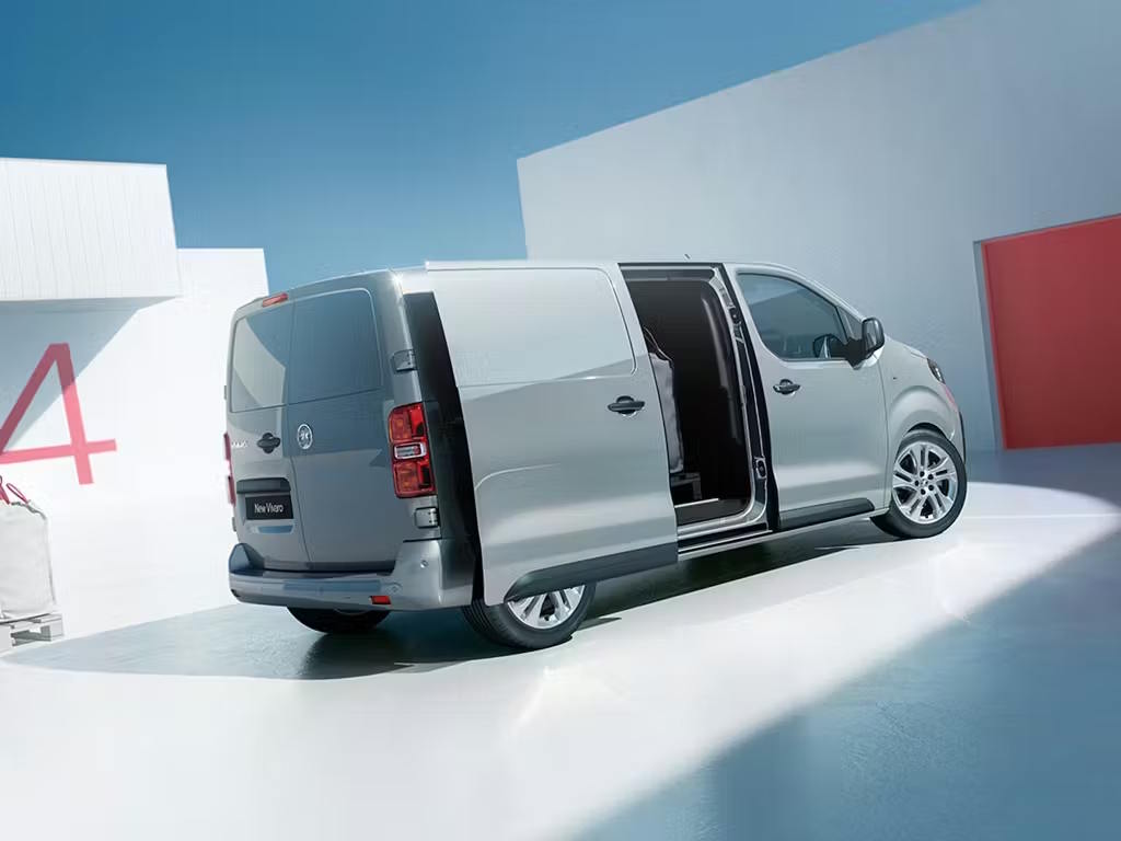 Grey Vauxhall Vivaro van displayed in a bright studio with the sliding side door open.