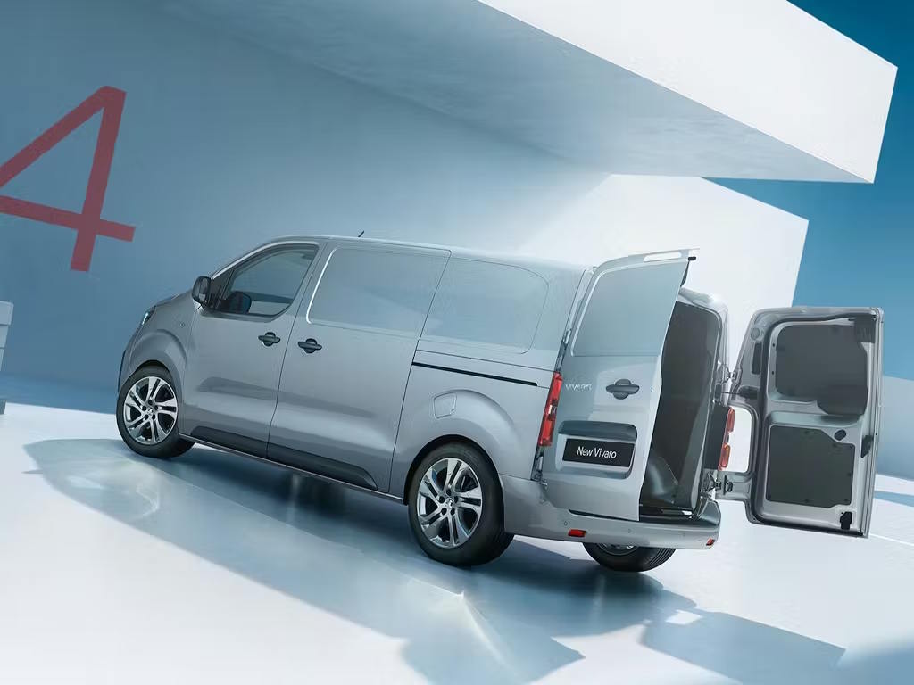 Grey Vauxhall Vivaro van displayed in a bright studio with the rear doors open.
