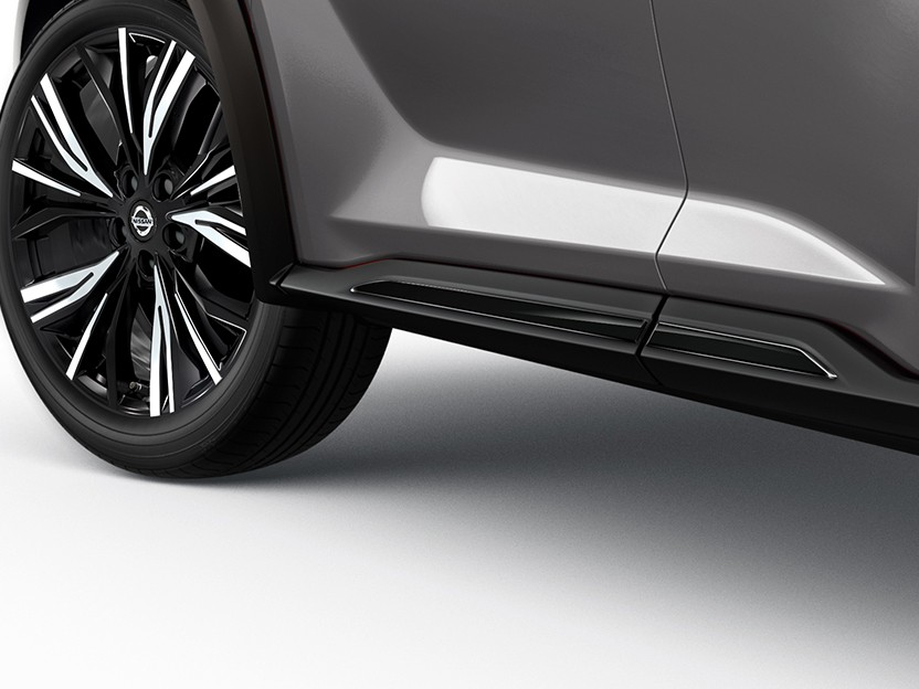 Close-up of a Nissan Qashqai lower side body panel and alloy wheel, highlighting the side skirt design and trim.