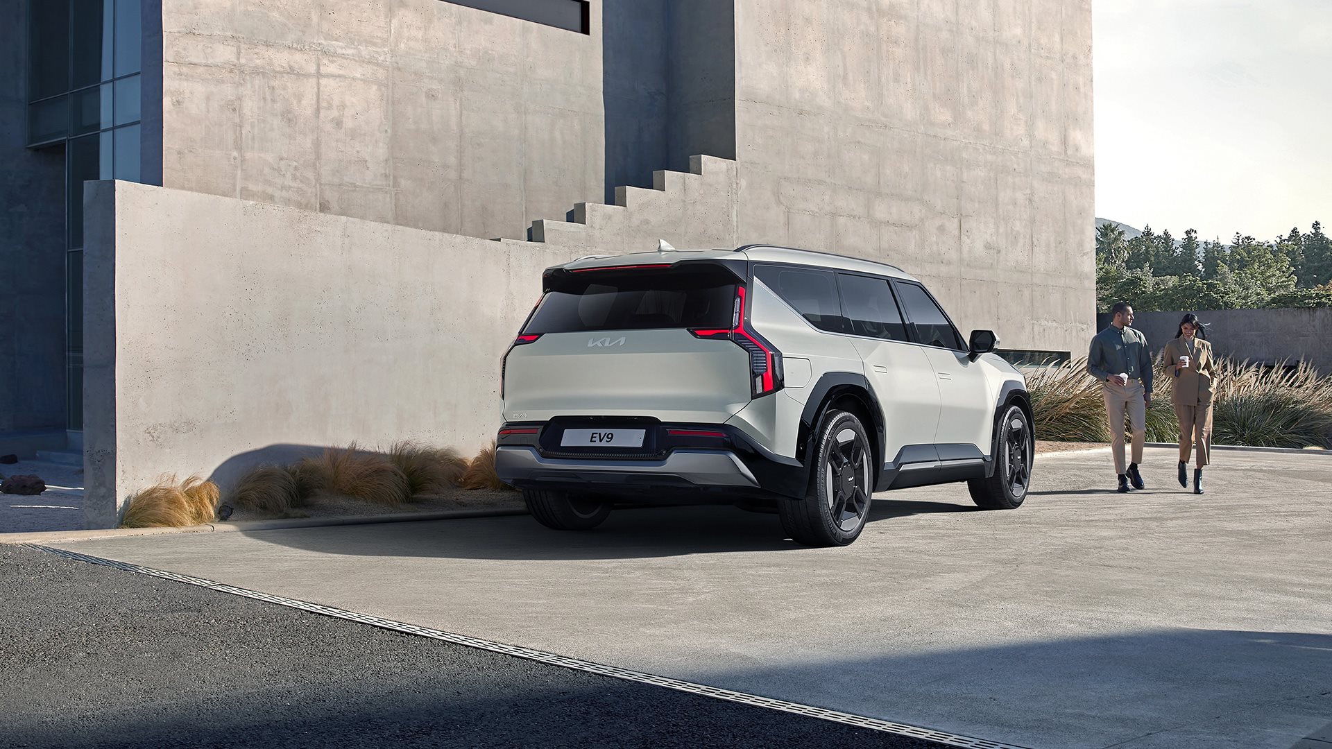 Kia EV9 parked by stone steps