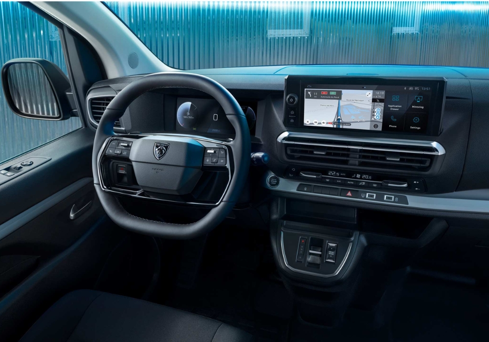 Peugeot e-Expert interior with steering wheel, digital driver display and central touchscreen infotainment system.
