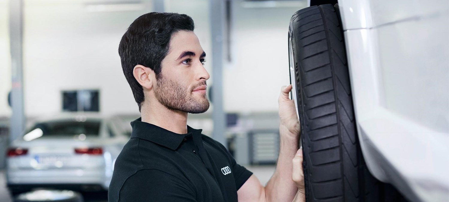 Mechanic Inspecting Tyre