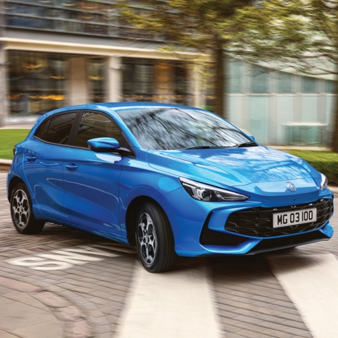 Close-up of an MG3 in blue driving in an urban environment.