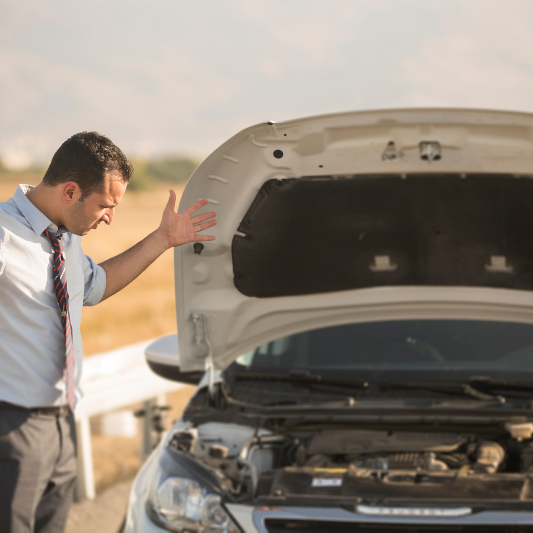 man having a breakdown on side of the road wearing a shirt and tie