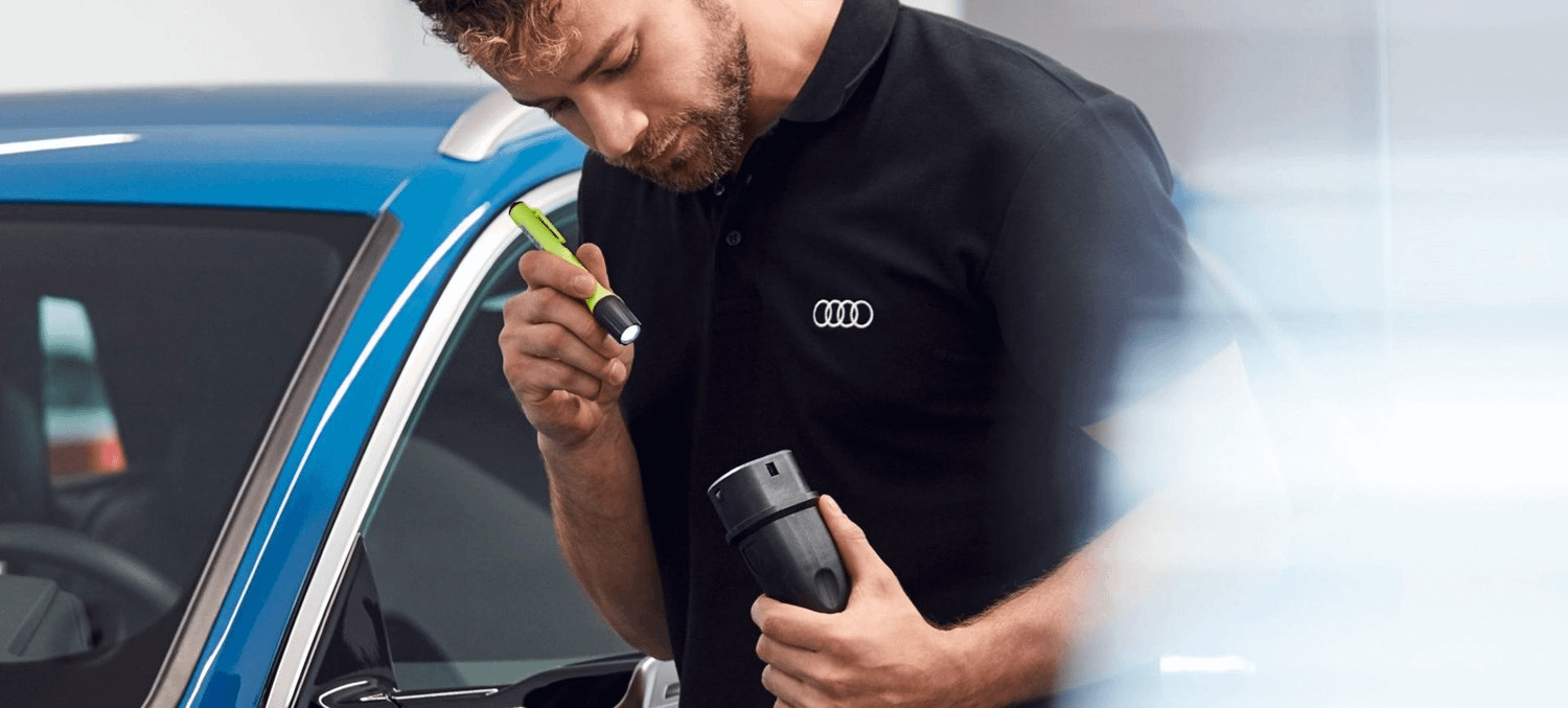 Audi Mechanic Inspecting vehicle