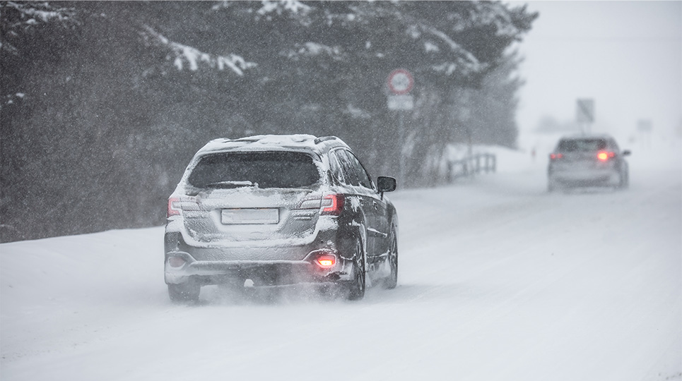 dark suv car driving on winter road
