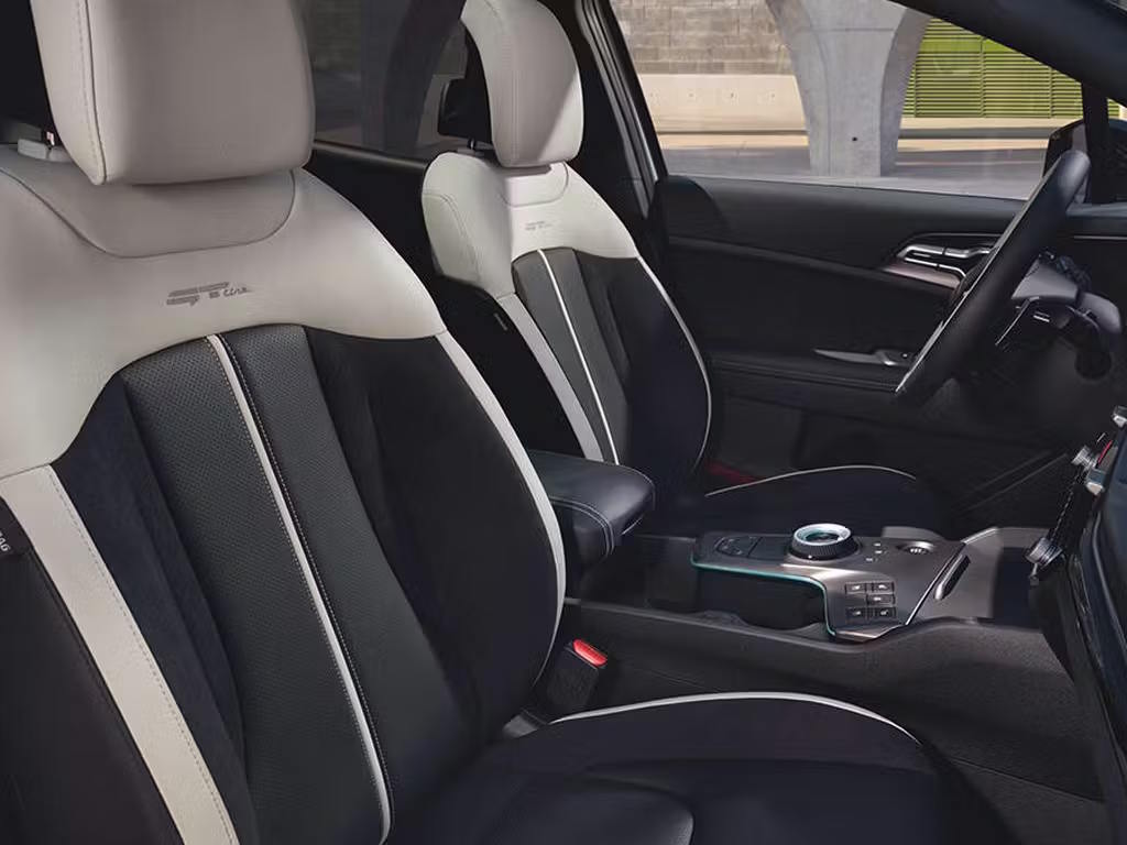 Kia Sportage GT-Line interior showcasing two-tone leather sports seats in black and grey, with contrast stitching, central rotary controller and modern centre console design.