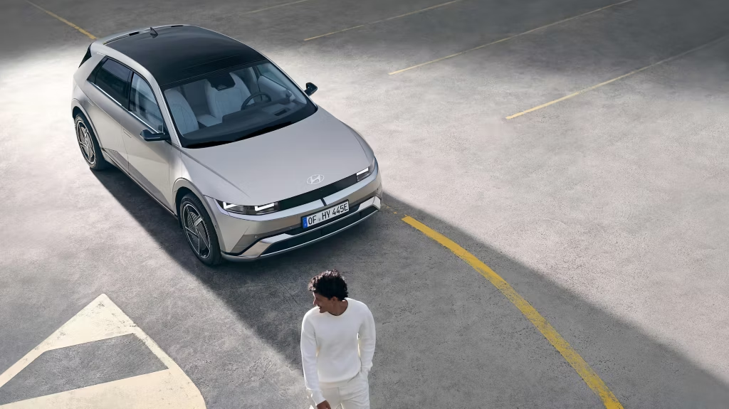 Man infront of a Hyundai EV