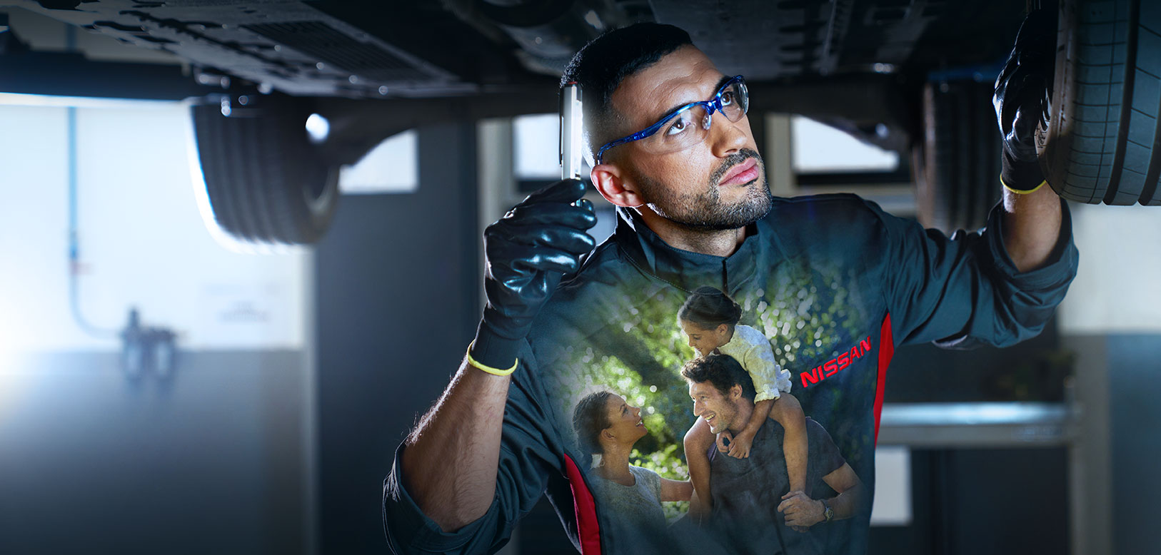 Nissan mechanic wearing a Nissan branded shirt