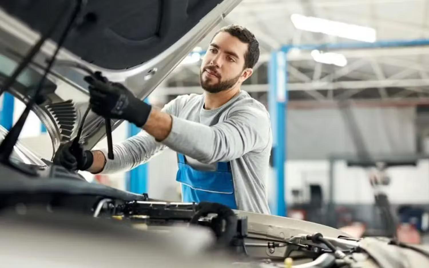 Volkswagen Mechanic Inspecting Window Wipers