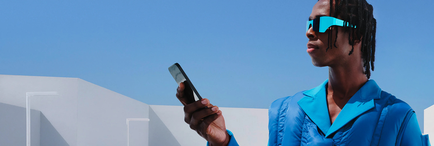 Person holding phone wearing sunglasses