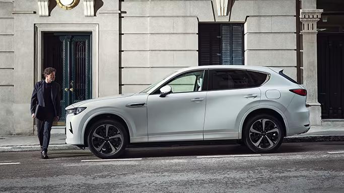 New white Mazda CX-60 Diesel parked on an urban street.