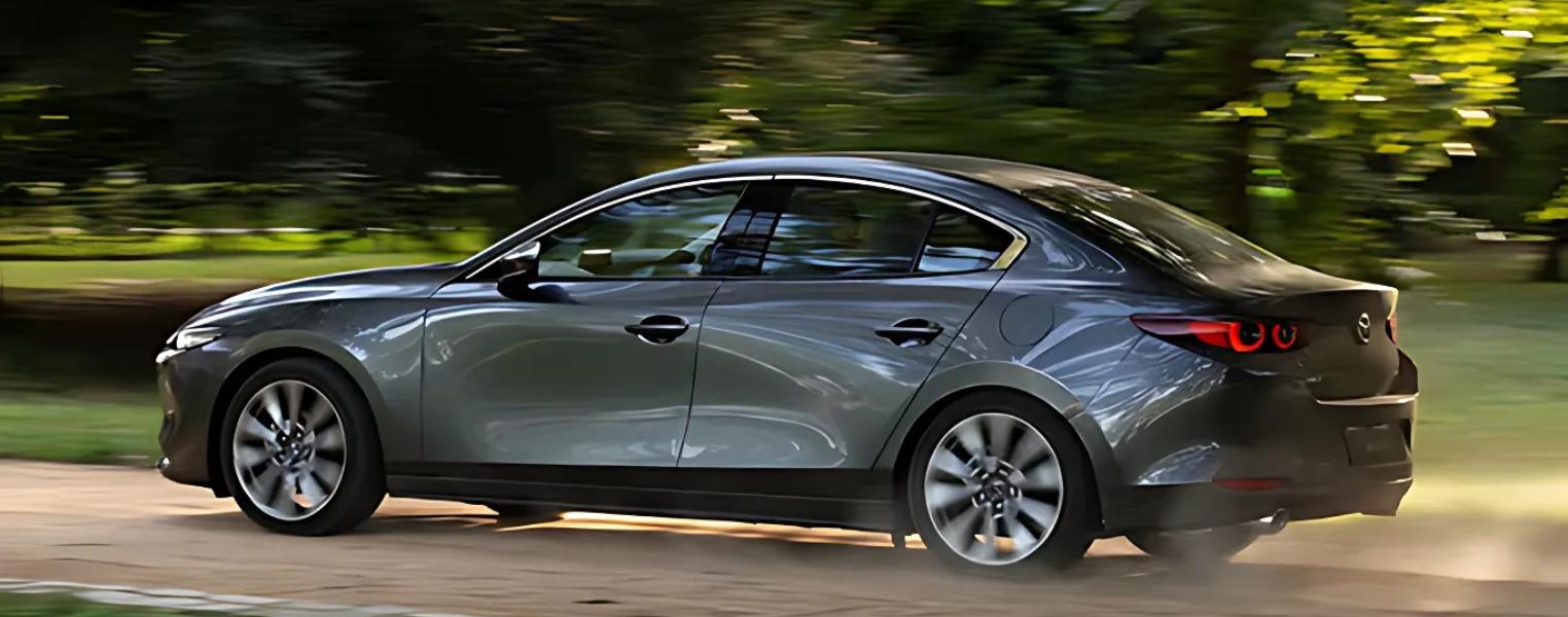 Mazda3 Saloon In Grey Driving Outdoors