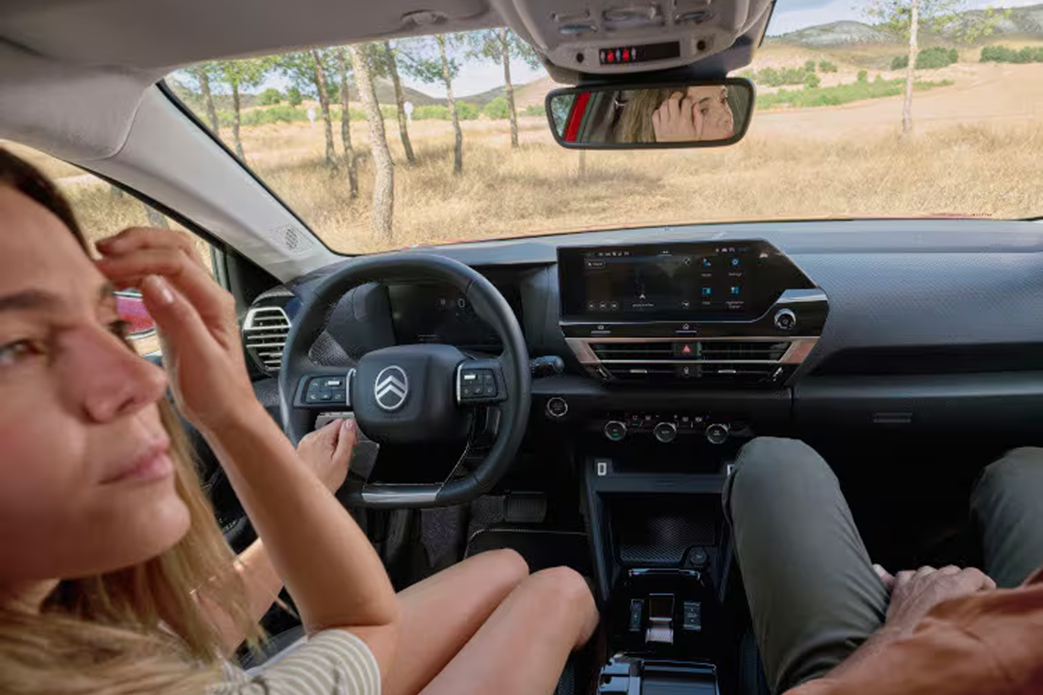 lady and another person sat in front of New C4 with view of dashboard