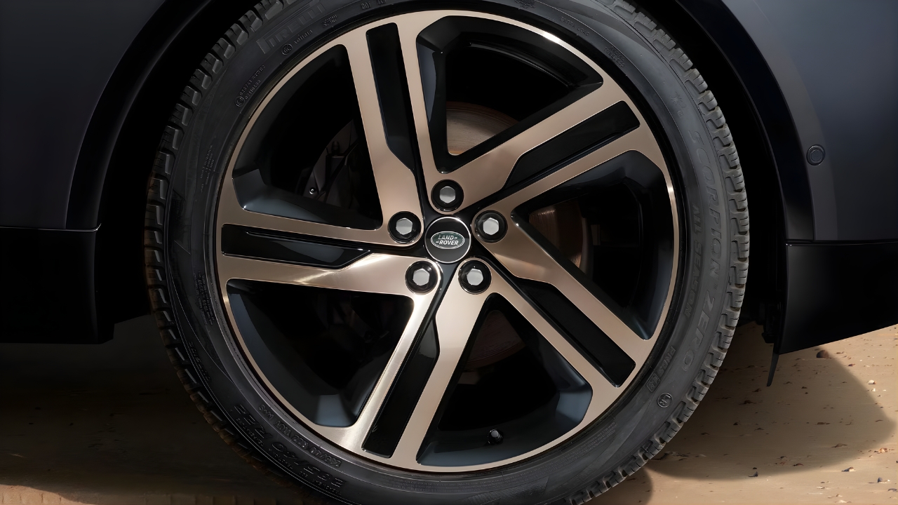 Close-up of a Land Rover Discovery Tempest alloy wheel and tyre on sandy terrain.