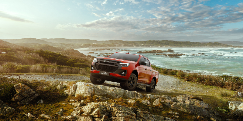 Red Isuzu D-Max Utility by the river