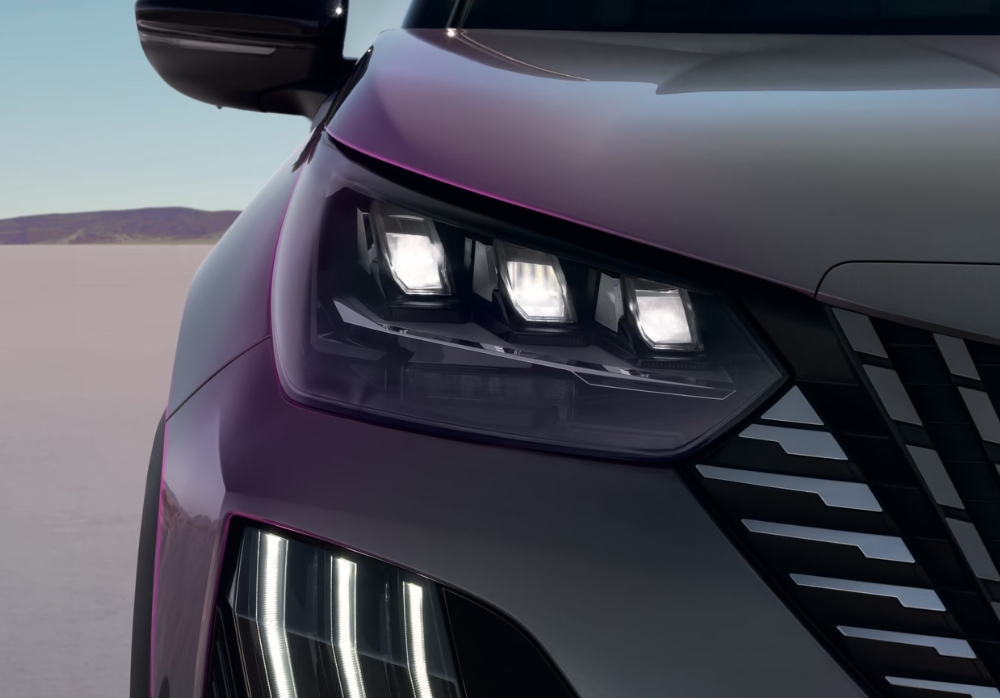 Peugeot 2008 front headlight detail featuring LED lighting and distinctive vertical daytime running lights.