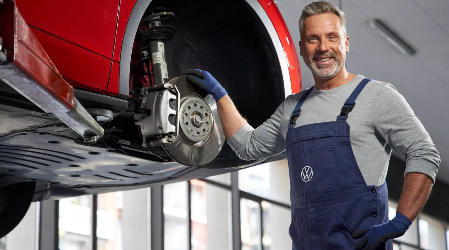 Mechanic Posing with Volkswagen Wheel