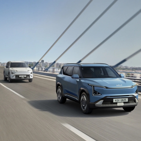 Pair Of Kia Ev5 Driving In An Urban Road