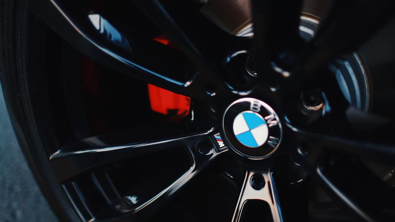 Close-up of BMW alloy wheel with red brake caliper.