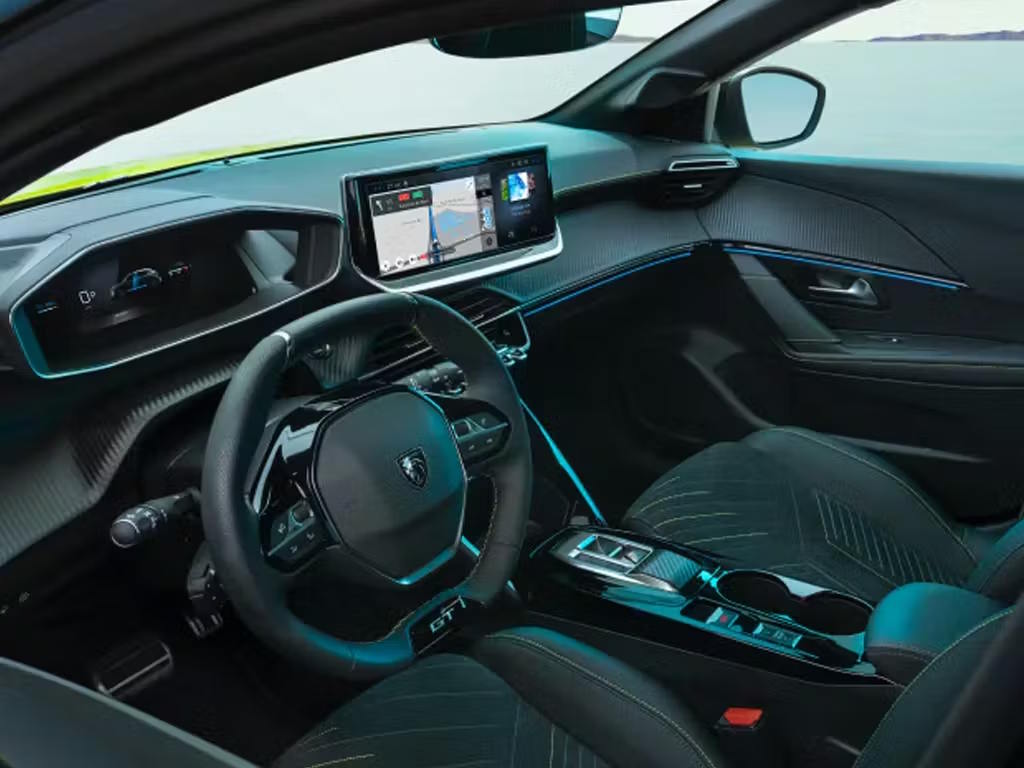 Peugeot E-208 interior featuring the i-Cockpit dashboard, digital driver display, touchscreen infotainment system and premium cabin design.