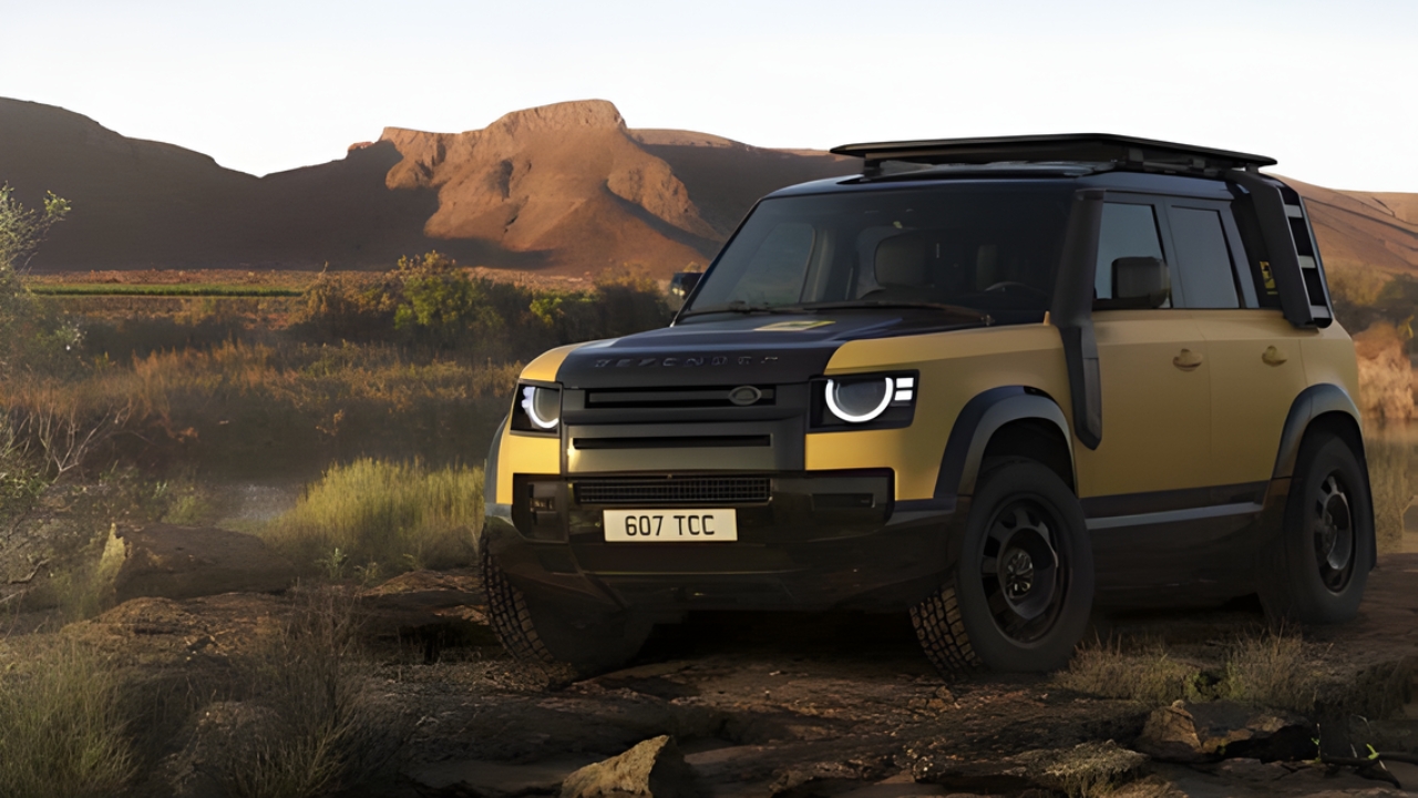 Front three-quarter view of the Defender Trophy Edition parked on rocky terrain in a desert landscape.