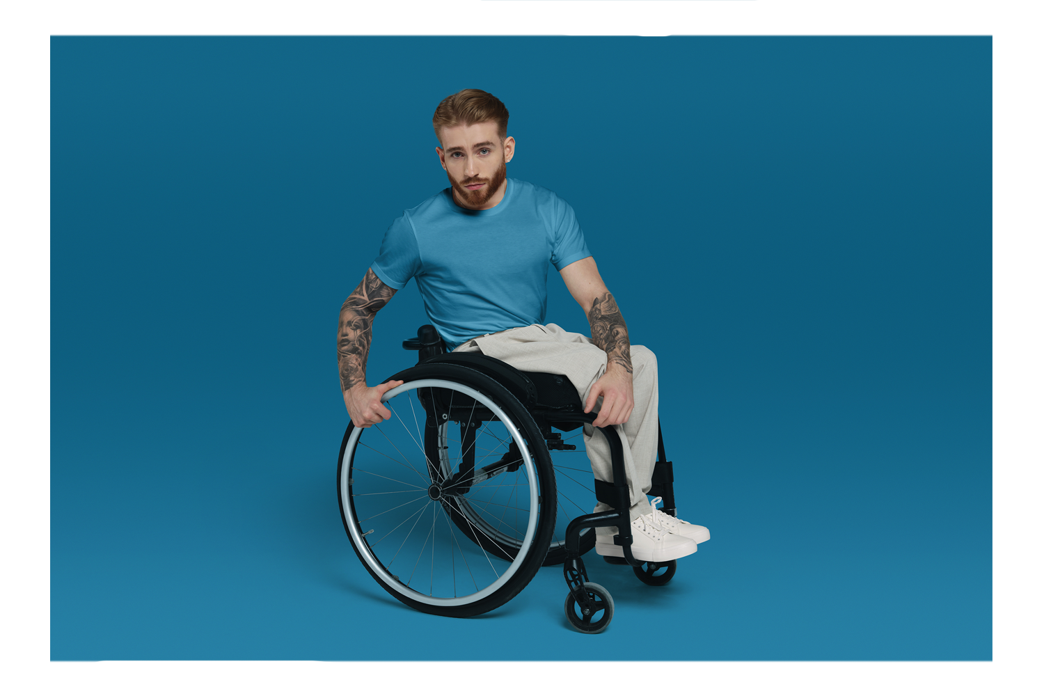 Man in a wheelchair with a blue background