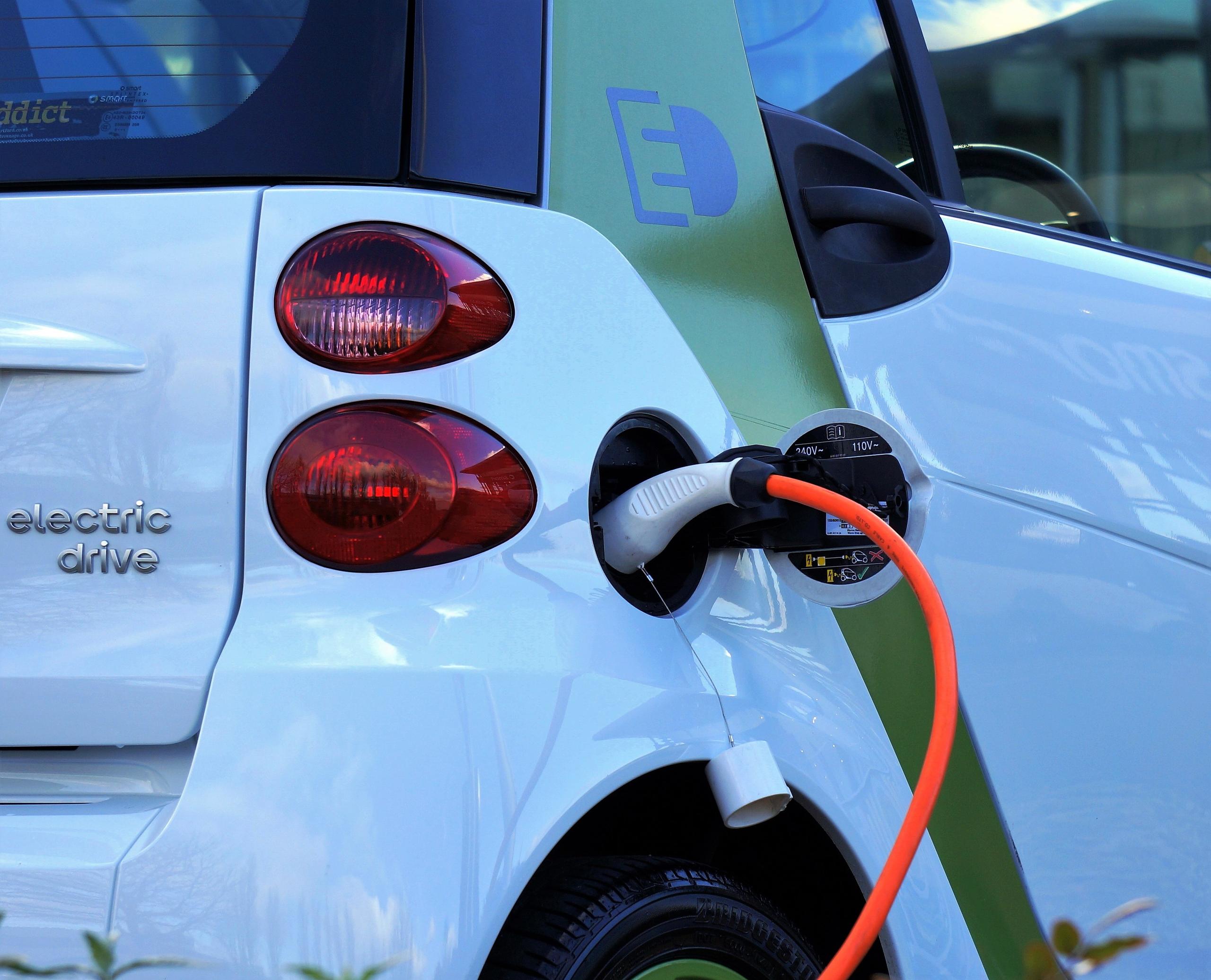 Electric car plugged into charging point