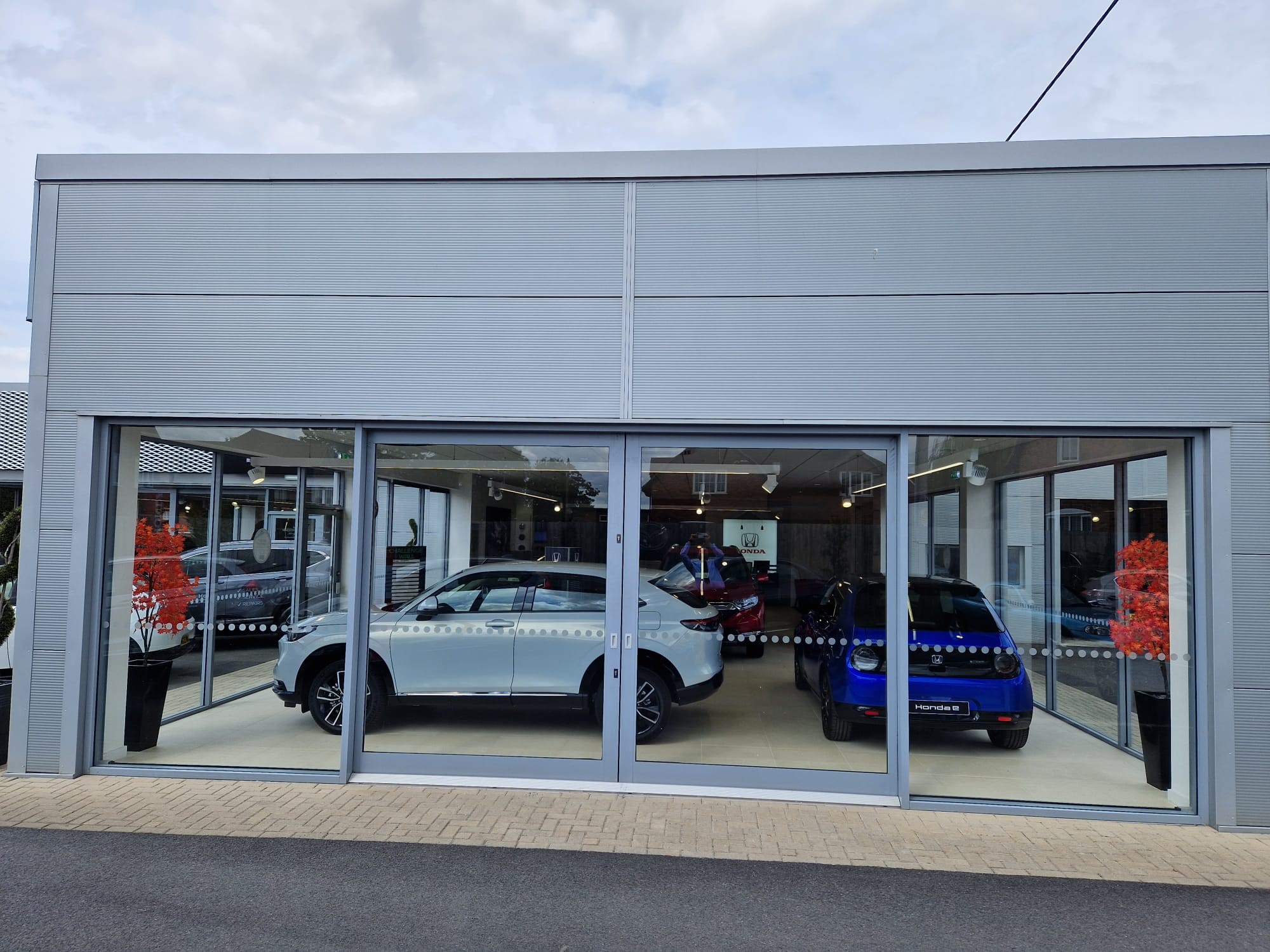 Cars on display through window at Horizon Honda Salisbury