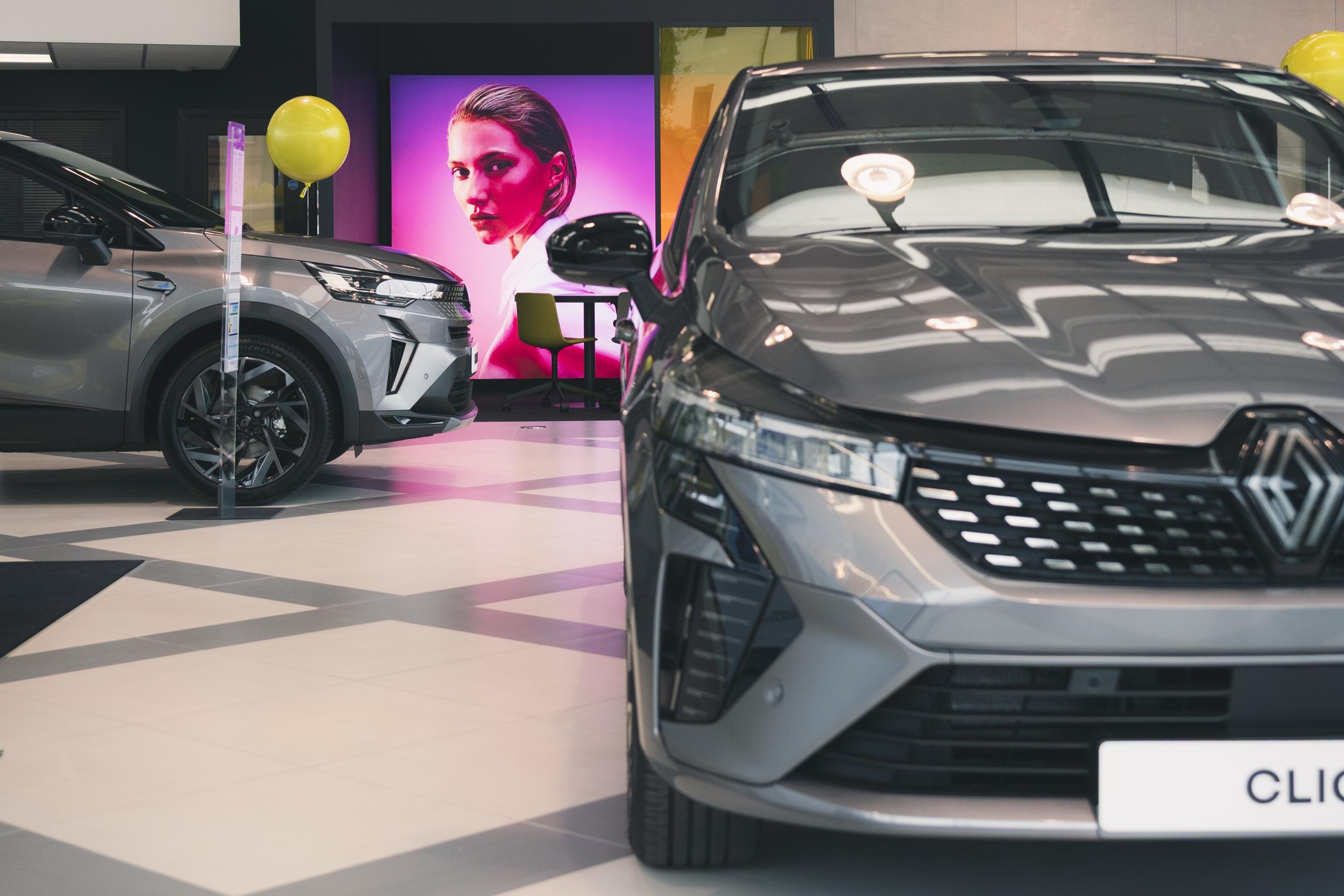 Car in showroom with yellow balloons
