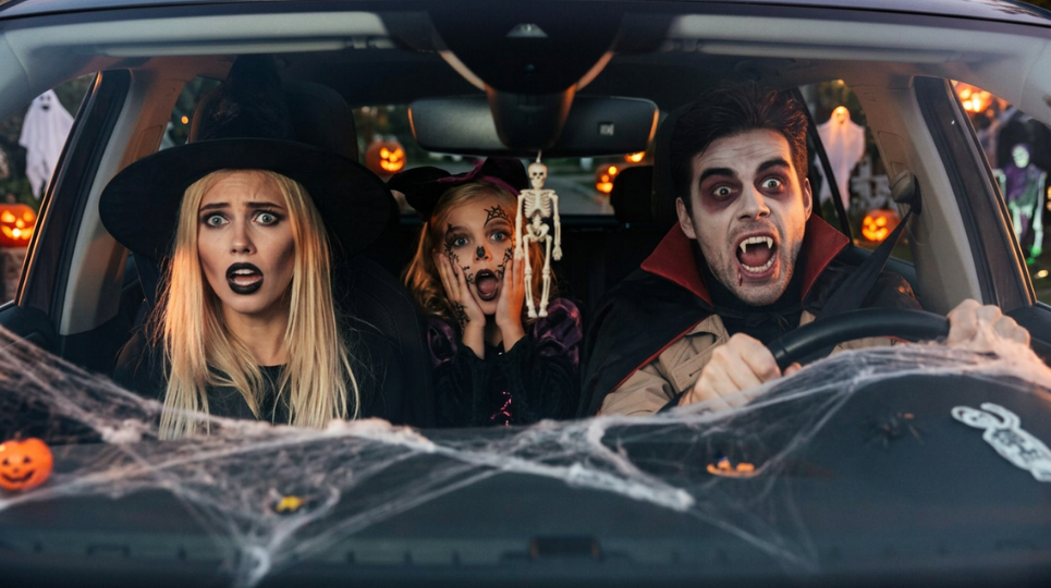 Family in car at halloween with scared expressions